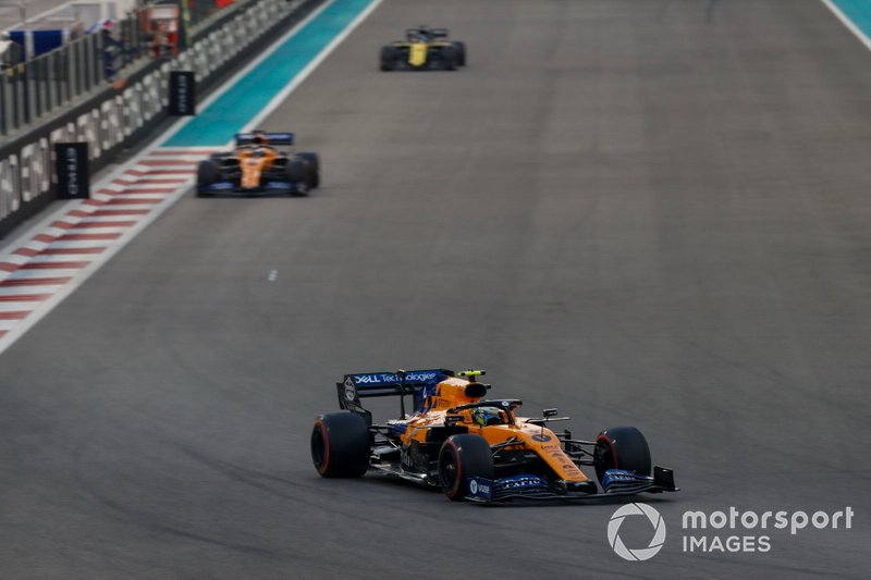 Lando Norris, McLaren MCL34, leads Carlos Sainz Jr., McLaren MCL34, and Daniel Ricciardo, Renault F1 Team R.S.19