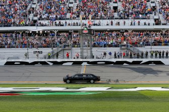 President Donald J. Trump and First Lady Melania Trump ride in the presidential car as they lead the field on the parade lap at the Daytona 500