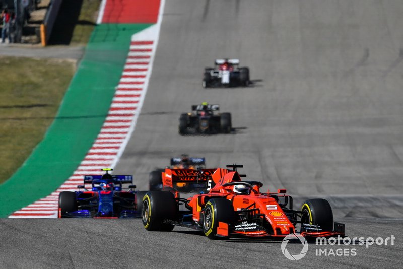 Sebastian Vettel, Ferrari SF90, leads Pierre Gasly, Toro Rosso STR14, Carlos Sainz Jr., McLaren MCL34, Kevin Magnussen, Haas F1 Team VF-19, and Kimi Raikkonen, Alfa Romeo Racing C38