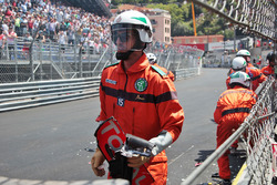 Marshals clear the debris from the Red Bull Racing RB12 of Max Verstappen, Red Bull Racing