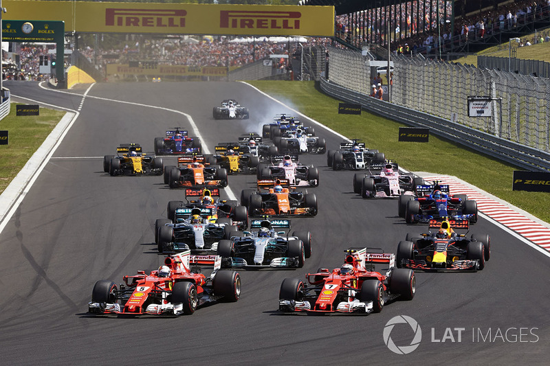 Sebastian Vettel, Ferrari SF70H, Kimi Raikkonen, Ferrari SF70H, lead the field away at the start