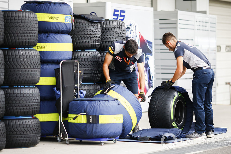 Scuderia Toro Rosso mechanics work on tyres in the paddock