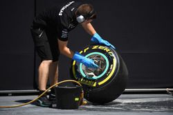 Mercedes AMG F1 mechanic cleans Pirelli tyre