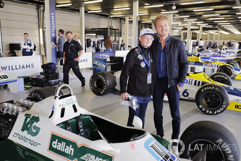 Nico Rosberg poses with a young fan