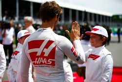 Romain Grosjean, Haas F1 Team, high fives a Grid Kid