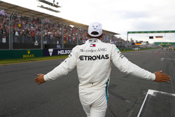 Lewis Hamilton, Mercedes AMG F1, celebrates taking pole position alongside on the pit straight