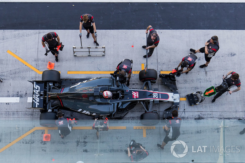 Kevin Magnussen, Haas F1 Team VF-17, is attended to by pit crew