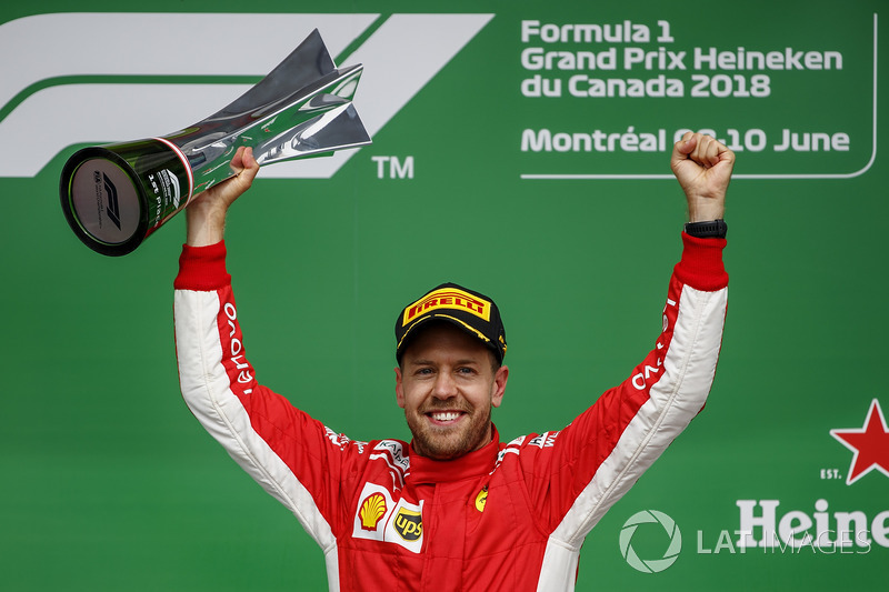 Sebastian Vettel, Ferrari, 1st position, celebrates with his trophy on the podium