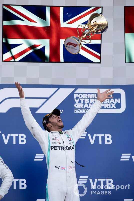 Race winner Lewis Hamilton, Mercedes AMG F1 throws his trophy in the air on the podium