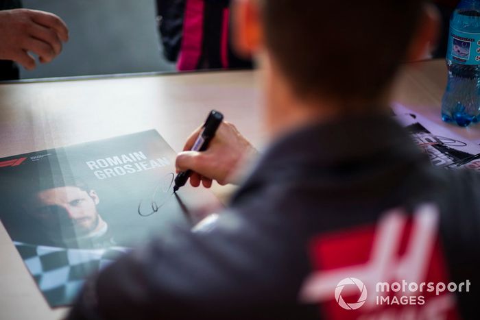 Romain Grosjean, Haas F1 Team signs autographs