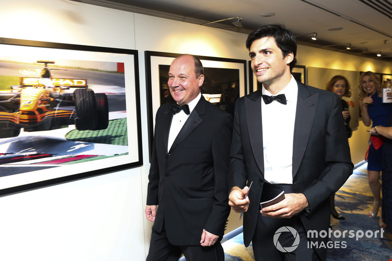 Carlos Sainz walks through the Motorsport Images display
