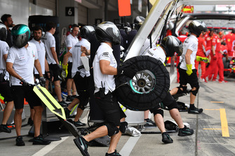 Mercedes AMG F1 mechanic and Pirelli tyre