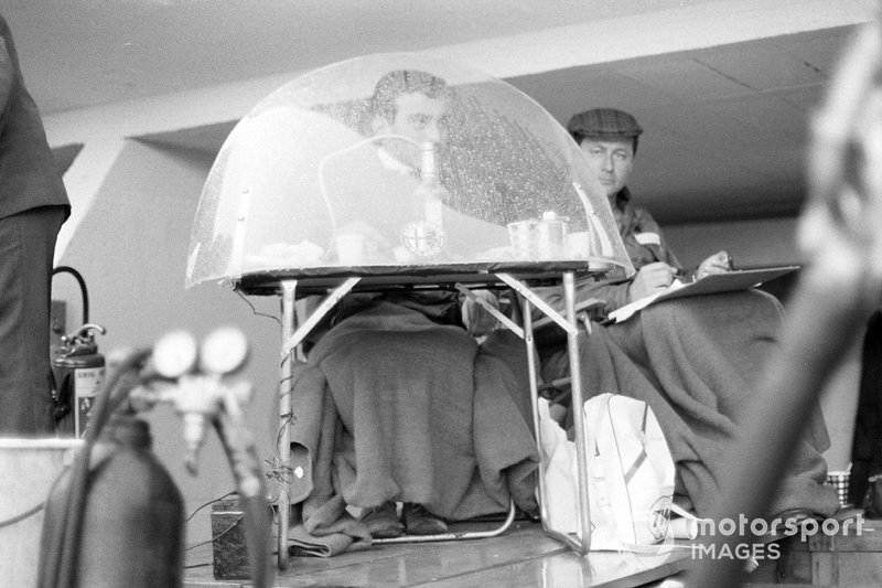 An Alfa Romeo timekeeper in the pits during a rain shower