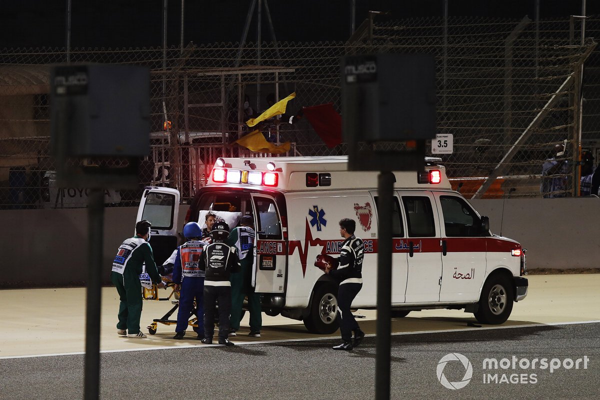 Medical delegates assist Romain Grosjean, Haas F1, after his first lap crash