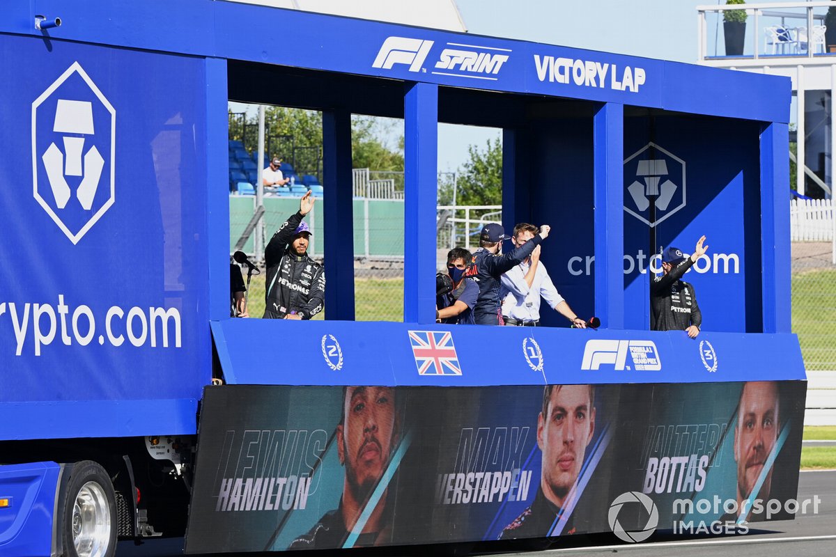 Max Verstappen, Red Bull Racing, 1st position, Lewis Hamilton, Mercedes, 2nd position, and Valtteri Bottas, Mercedes, 3rd position, tour the circuit in the victory lap truck after Sprint Qualifying