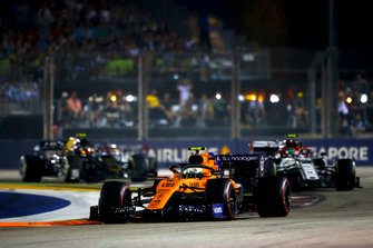 Lando Norris, McLaren MCL34, leads Antonio Giovinazzi, Alfa Romeo Racing C38, and Kevin Magnussen, Haas F1 Team VF-19, at the start