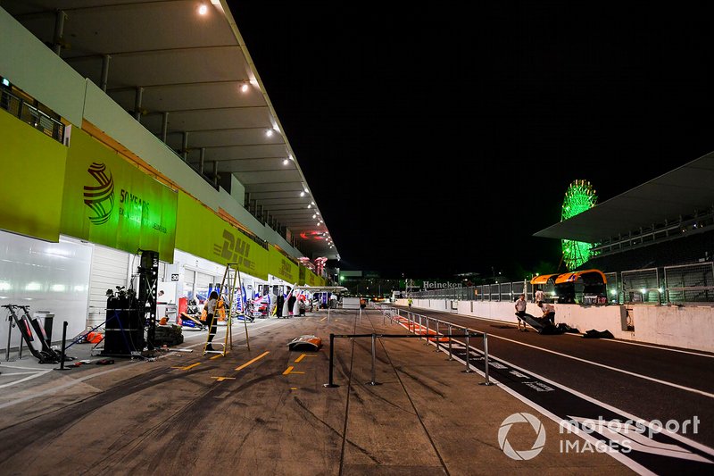McLaren team members dismantle the pit wall in preparation for the impending Typhoon Hagibis