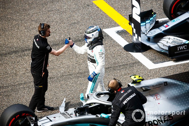 Pole man Valtteri Bottas, Mercedes AMG F1, celebrates with mechanics on the grid