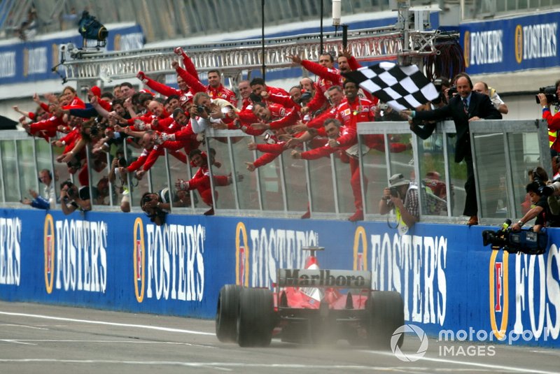 Race winner Michael Schumacher, Ferrari F2002, takes the chequered flag