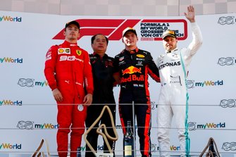 Charles Leclerc, Ferrari, 2nd position, Toyoharu Tanabe, F1 Technical Director, Honda, Max Verstappen, Red Bull Racing, 1st position, and Valtteri Bottas, Mercedes AMG F1, 3rd position, on the podium