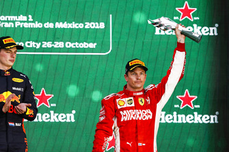 Kimi Raikkonen, Ferrari, 3rd position, lifts his trophy
