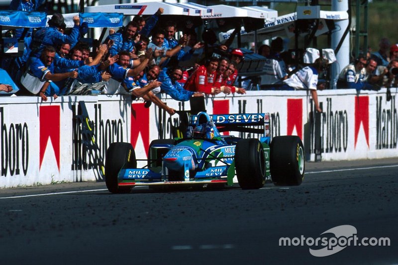 Michael Schumacher, Benetton B194, celebrates with the Benetton team as he crosses the finish line