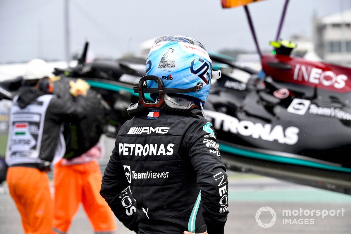 Valtteri Bottas, Mercedes, walks away from his damaged car after crashing out at the start