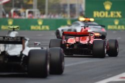 Kimi Raikkonen, Ferrari SF71H and Kevin Magnussen, Haas F1 Team VF-18