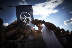 Lewis Hamilton, Mercedes AMG F1, poses for a picture with fans