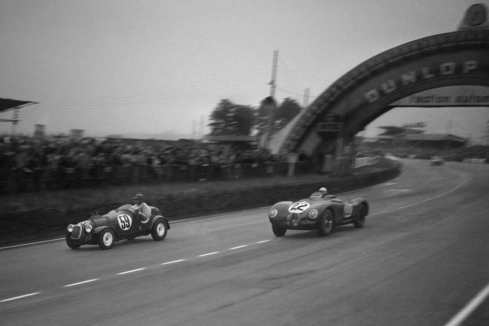 #22 Jaguar XK 120 C: Stirling Moss, Jack Fairman overtakes #59 Crosley Motors: George Schrafft, Phil Stiles after the Dunlop curve