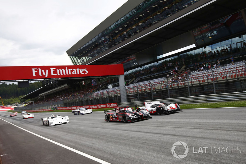 A parade of sportscars, featuring Audi R18 LMP1 and Porsche 919 LMP1 cars, a BMW V12 LMR, Porsche 96