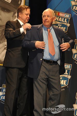 Brian France (L), CEO and Chairman of NASCAR, puts the Hall of Fame jacket on inductee Jack Ingram