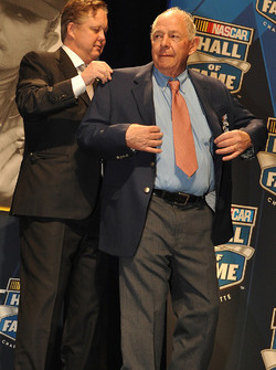 Brian France (L), CEO and Chairman of NASCAR, puts the Hall of Fame jacket on inductee Jack Ingram