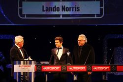 Lando Norris is presented with the British Club Driver of the Year trophy by Vijay Mallya