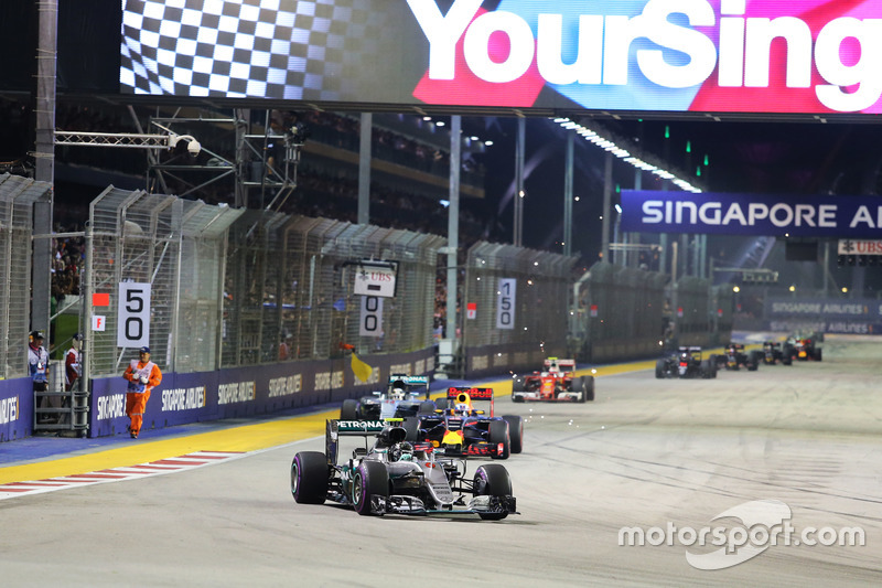 A marshal runs along the circuit as Nico Rosberg, Mercedes AMG F1 W07 Hybrid leads at the restart