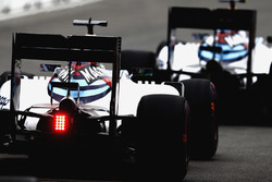 Valtteri Bottas, Williams FW38, leads Felipe Massa, Williams FW38, out of the pit lane