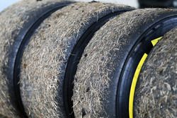 Worn Pirelli tyres covered in grass