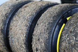 Worn Pirelli tyres covered in grass