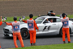 Marhals wave at Charlie Whiting, FIA Delegate in the FIA Safety Car