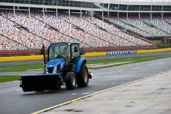 A Charlotte Motor Speedway track worker works on drying the track