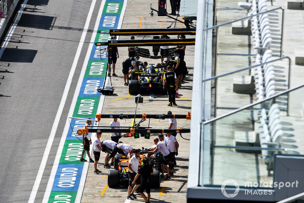 Daniel Ricciardo, Renault F1 Team R.S.20, and Carlos Sainz Jr., McLaren MCL35, in pit lane