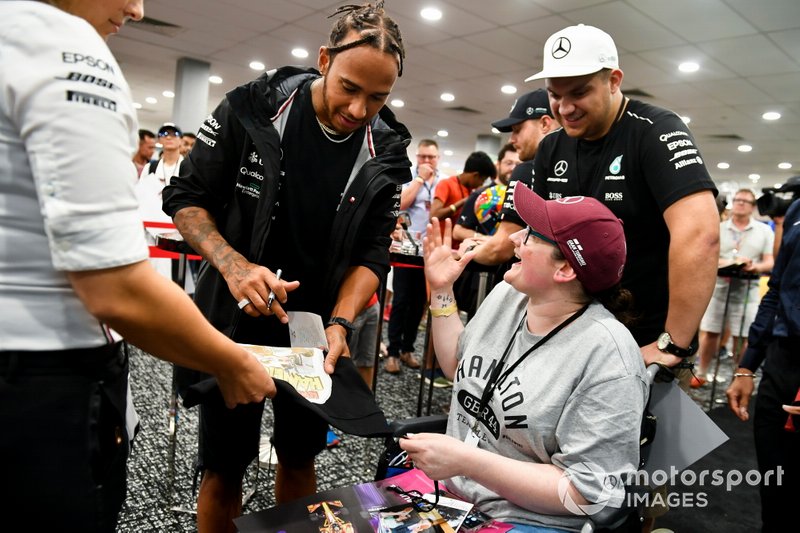Lewis Hamilton dá autógrafo