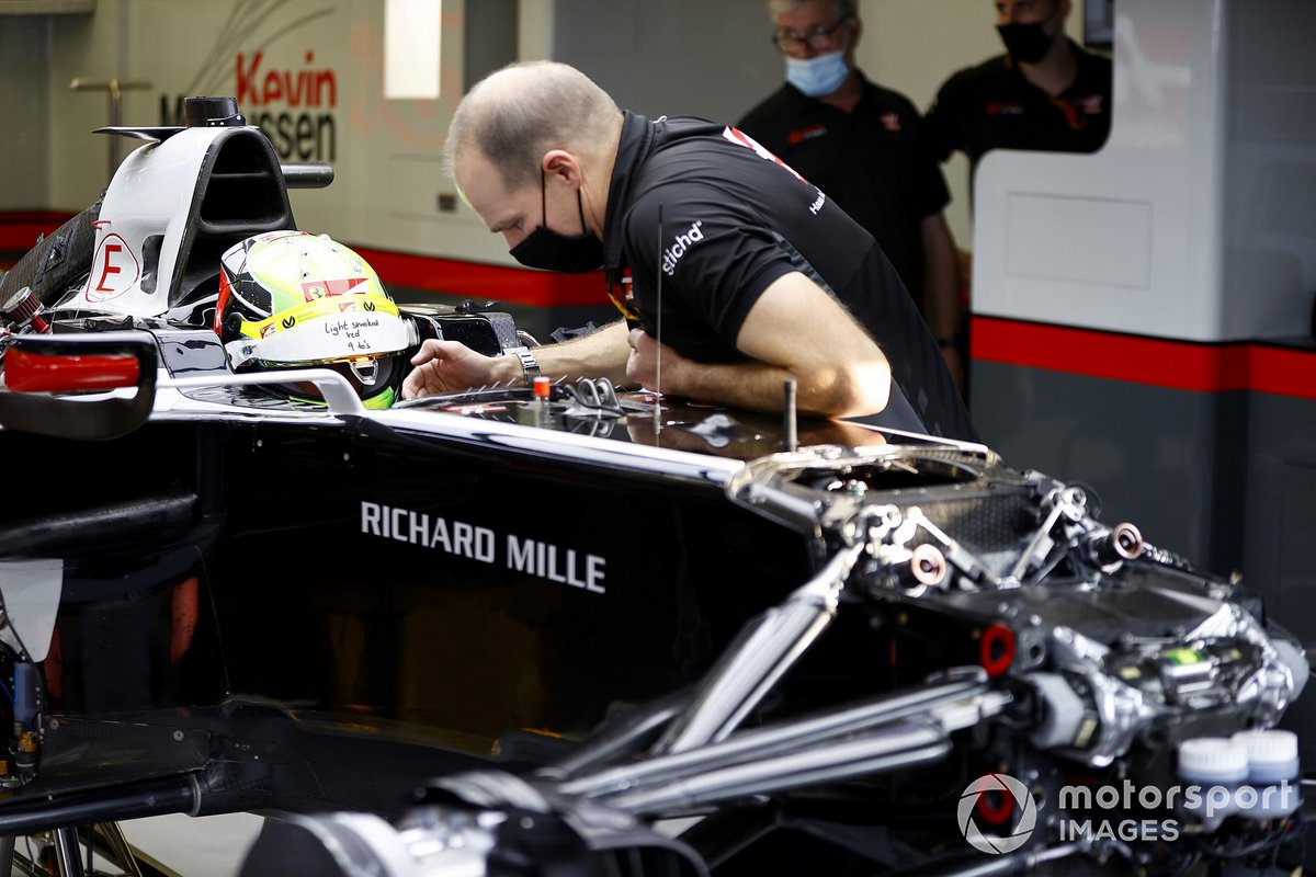 Mick Schumacher sits in his Haas VF-20 for his seat fitting with race engineer Gary Gannon