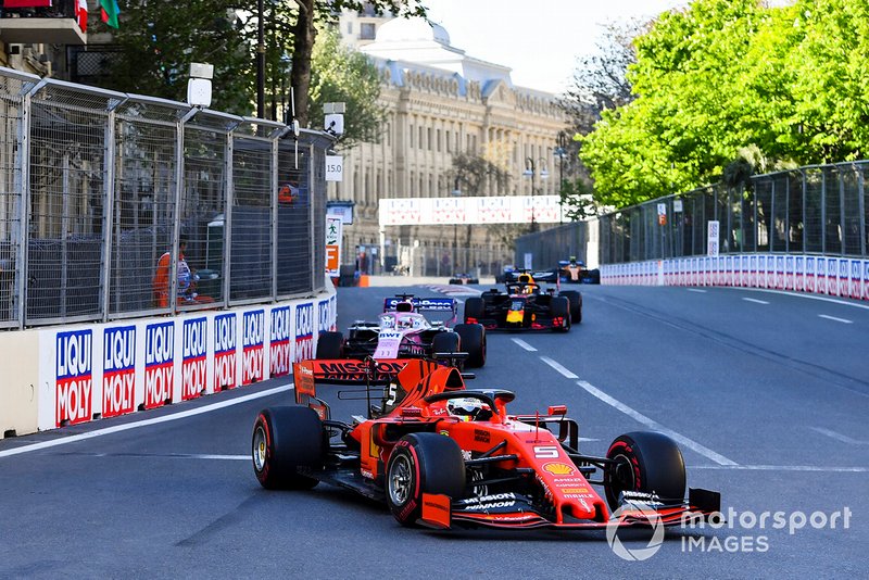 Sebastian Vettel, Ferrari SF90, leads Sergio Perez, Racing Point RP19, and Max Verstappen, Red Bull Racing RB15