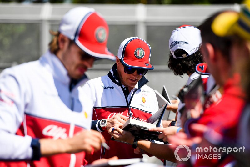 Kimi Raikkonen, Alfa Romeo Racing and Antonio Giovinazzi, Alfa Romeo Racing sign autographs for fans