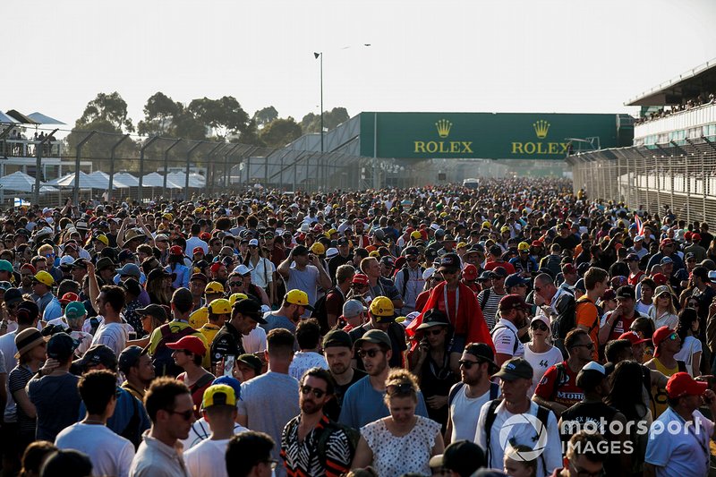 Fans flood the circuit after the race