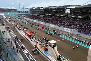 Will Smith waves the flag of the United Arab Emirates ahead of the start of the race.