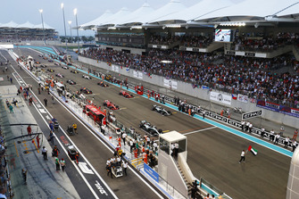Will Smith waves the flag of the United Arab Emirates ahead of the start of the race.