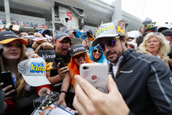 Fernando Alonso, McLaren, poses for fans to take pictures