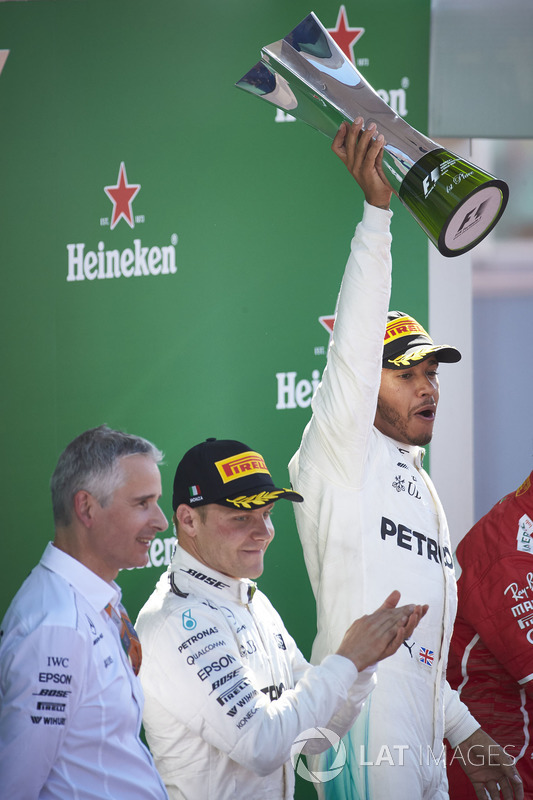 Second place Valtteri Bottas, Mercedes AMG F1, applauds as Race winner Lewis Hamilton, Mercedes AMG F1, raises the winners trophy